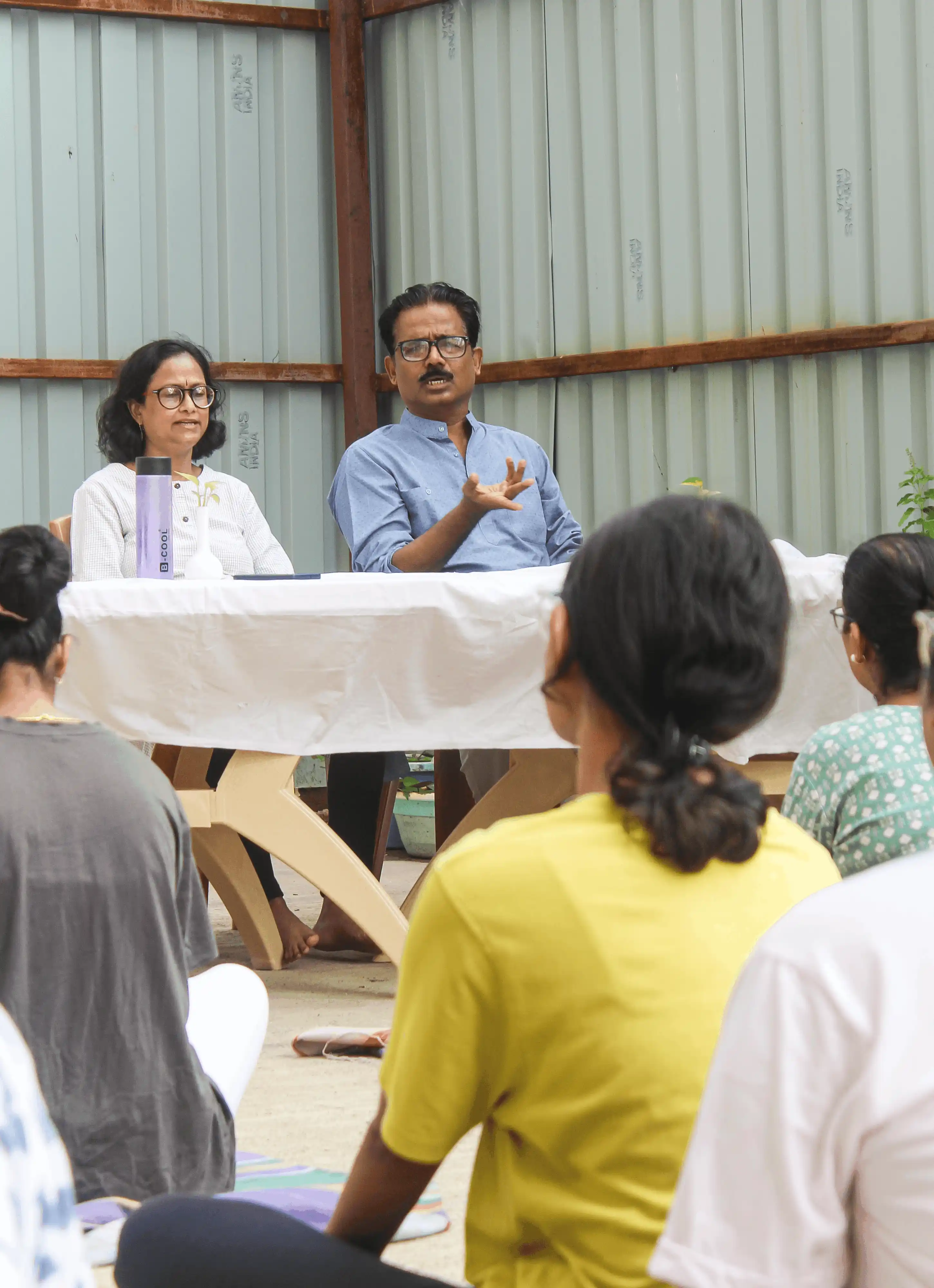 Group of students sitting attentively during an indoor yoga workshop